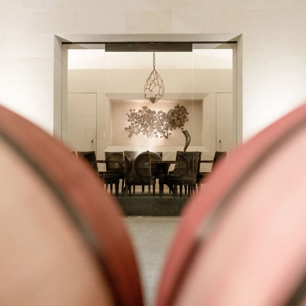 Private room in caves with table for guests and artwork behind.